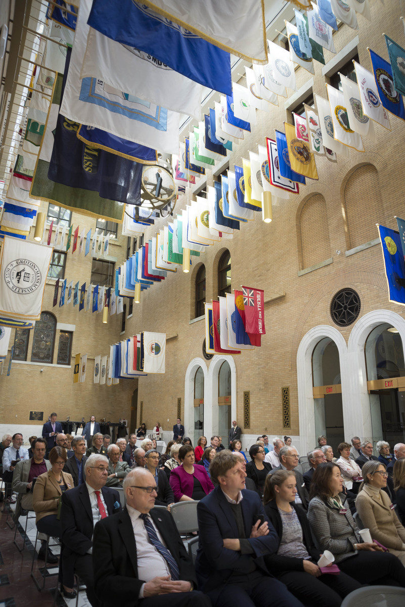 Crowd seated for event inside government building